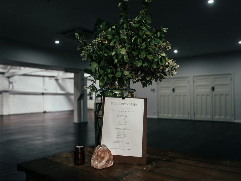 Clean and minimalist yoga studio interior with soft lighting.